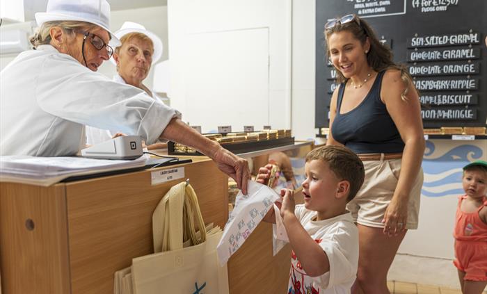Visitors purchasing Caldey Island chocolate and fudge in the Chocolate factory